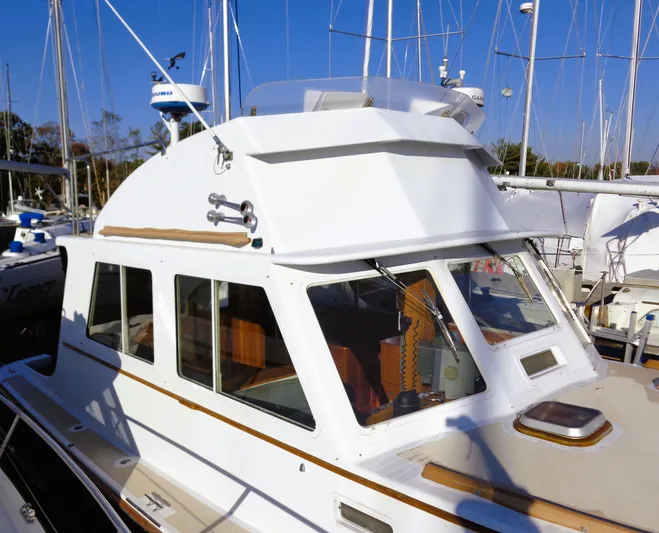 Hi Yo Silver Yacht Photos Pics 1990 Pettegrow 36 Flybridge boat with white cabin and flybridge, docked at marina.