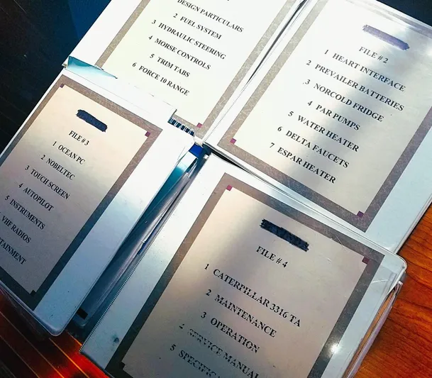 Hi Yo Silver Yacht Photos Pics Binders with technical manuals for Pettegrow 36 Flybridge, 1990 model, on a wooden surface.