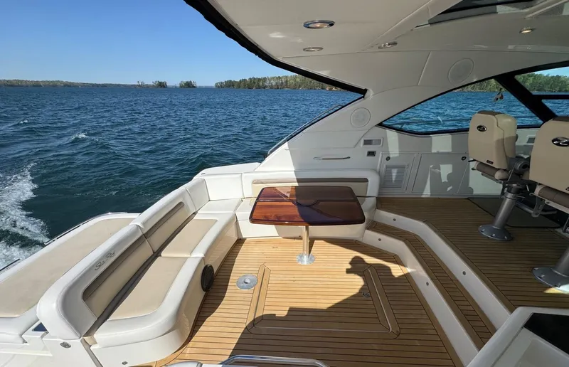 Costas Yacht Photos Pics 2015 Sea Ray 540 Sundancer yacht with spacious deck and seating, cruising on open water.