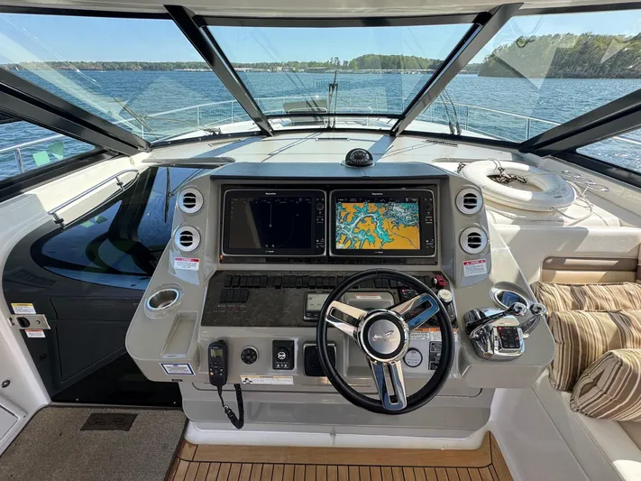 Costas Yacht Photos Pics Cockpit of 2015 Sea Ray 540 Sundancer yacht with navigation screens and steering wheel.
