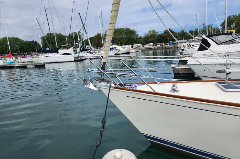 Isola Bella Yacht Photos Pics 1988 Sabre 42 sailboat docked in a marina with other boats.