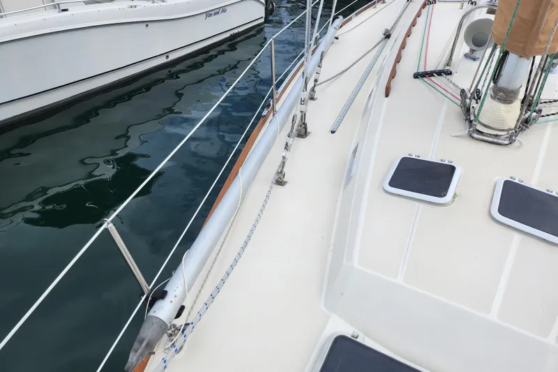 Isola Bella Yacht Photos Pics 1988 Sabre 42 sailboat deck with rigging and water reflection.