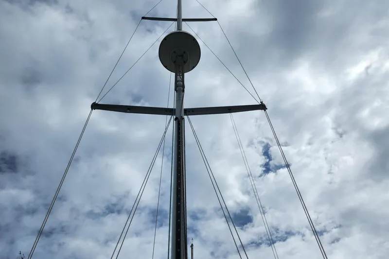 Isola Bella Yacht Photos Pics Mast of 1988 Sabre 42 sailboat against cloudy sky.