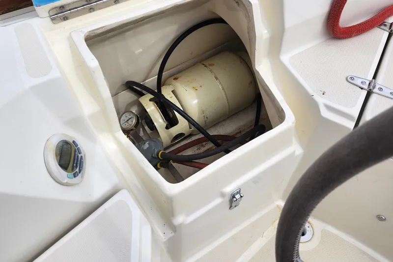 Isola Bella Yacht Photos Pics Compartment with propane tank and gauge on 1988 Sabre 42 boat deck.