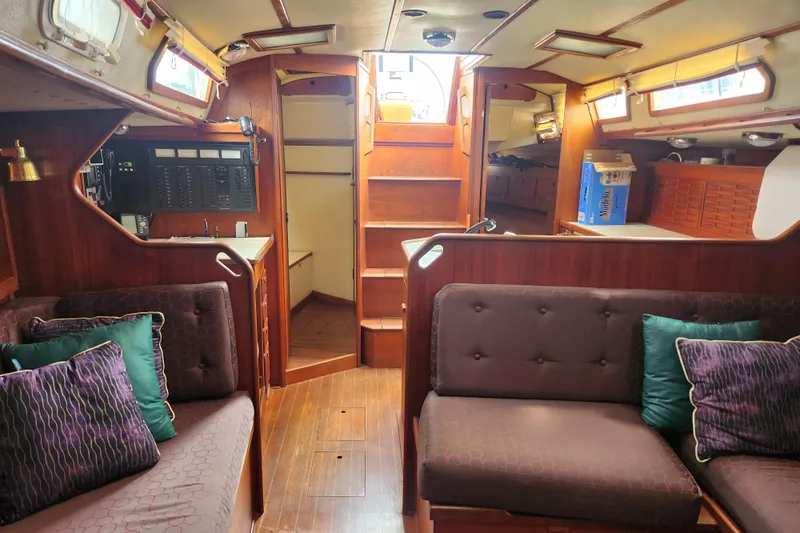 Isola Bella Yacht Photos Pics Interior of 1988 Sabre 42 sailboat with cozy seating and wooden finishes.
