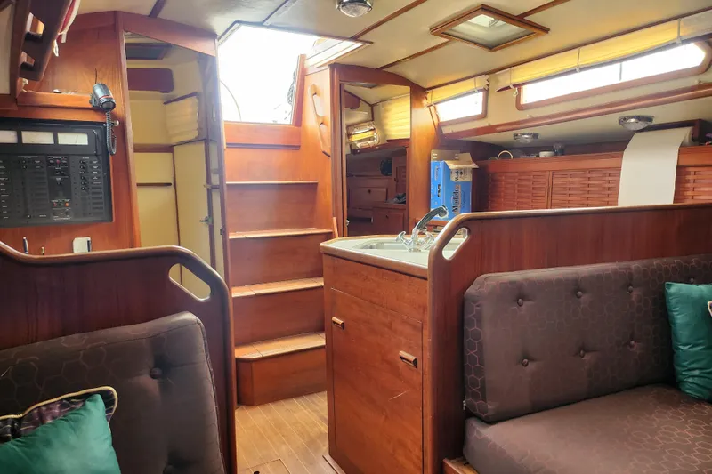 Isola Bella Yacht Photos Pics Interior of a 1988 Sabre 42 sailboat with wooden cabinetry and seating.