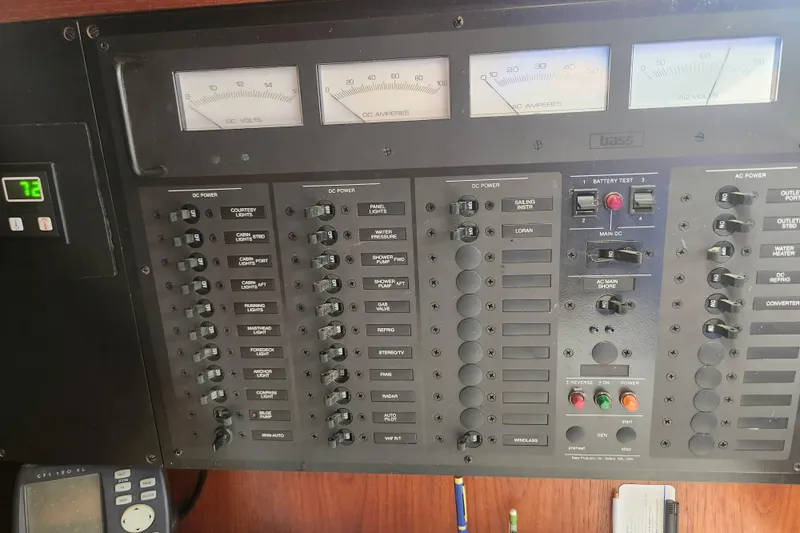 Isola Bella Yacht Photos Pics Electrical control panel on a 1988 Sabre 42 yacht, featuring various switches and gauges.