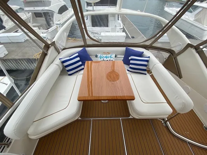  Yacht Photos Pics Luxurious seating area on 2000 Sea Ray 400 Sedan Bridge yacht with striped cushions.