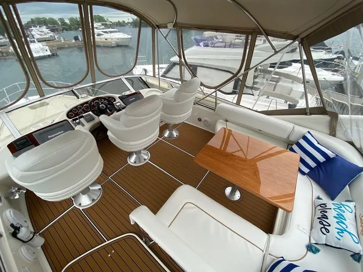  Yacht Photos Pics Luxurious 2000 Sea Ray 400 Sedan Bridge yacht interior with helm, seating, and waterfront view.
