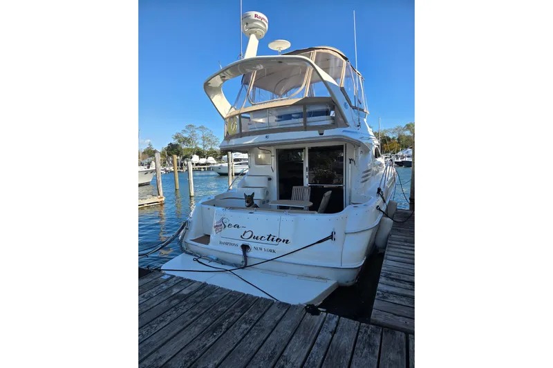  Yacht Photos Pics 2000 Sea Ray 400 Sedan Bridge yacht docked at marina, clear blue sky.