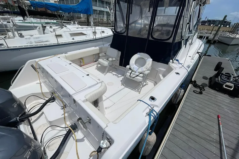  Yacht Photos Pics 2003 Grady-White Express 330 boat docked, featuring spacious deck and twin engines.