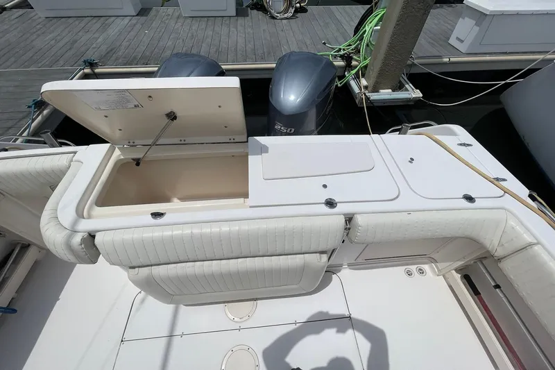  Yacht Photos Pics 2003 Grady-White Express 330 boat deck with open storage compartment and twin engines.