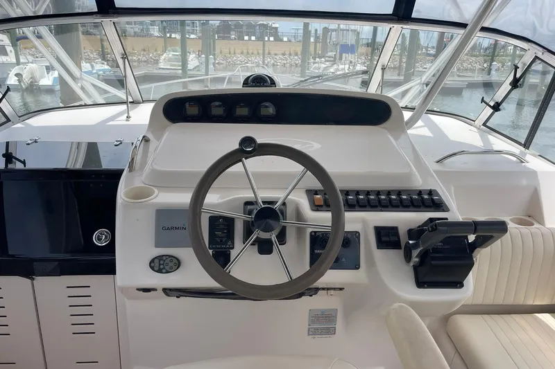  Yacht Photos Pics Helm of 2003 Grady-White Express 330 boat with steering wheel and controls.