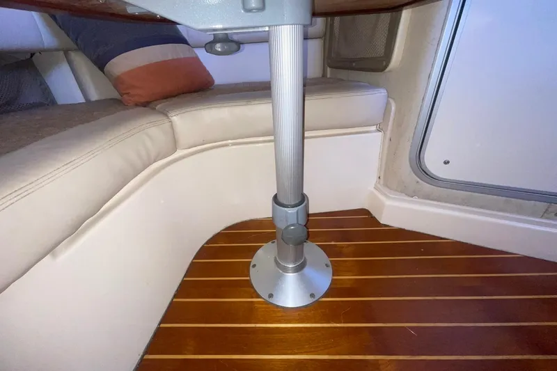  Yacht Photos Pics Interior of 2003 Grady-White Express 330 boat with wooden flooring and cushioned seating.