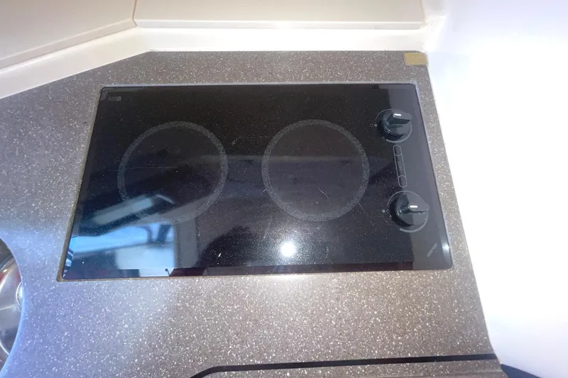  Yacht Photos Pics 2003 Grady-White Express 330 boat kitchen with a sleek black stovetop.