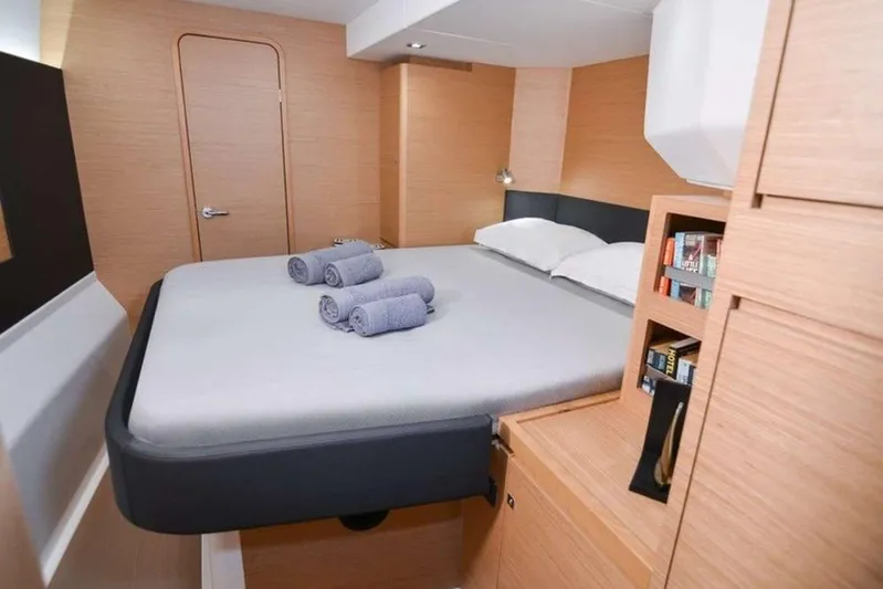  Yacht Photos Pics Luxurious cabin interior of 2020 Dufour Catamarans 48 with modern design and cozy bedding.