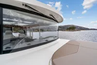 2021 Nimbus C11 boat with sleek design, cruising on a scenic lake.
