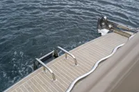 Nimbus C11 2021 boat deck with stainless steel ladder and calm water.