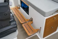 Interior of 2021 Nimbus C11 boat with wooden steps and storage compartments.