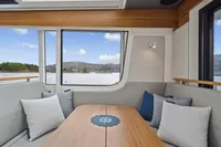 Interior of 2021 Nimbus C11 boat with cozy seating and scenic window view.