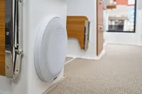 Interior of 2021 Nimbus C11 boat with speaker and wooden accents.
