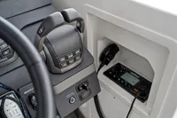 Control panel of 2021 Nimbus C11 boat with throttle and communication device.