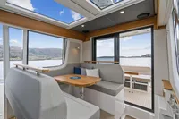 Interior of 2021 Nimbus C11 boat with modern seating and scenic water view.