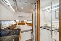 Luxurious interior of 2021 Nimbus C11 boat featuring a cozy cabin and modern kitchenette.