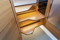 Wooden interior stairs in 2021 Nimbus C11 boat, featuring sleek design and warm lighting.