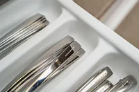 Silverware set in a white drawer, featuring Nimbus branding.