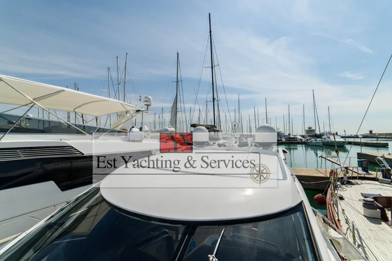  Yacht Photos Pics Sunseeker Predator 68 yacht docked at marina, 2004 model, clear sky, sailboats in background.