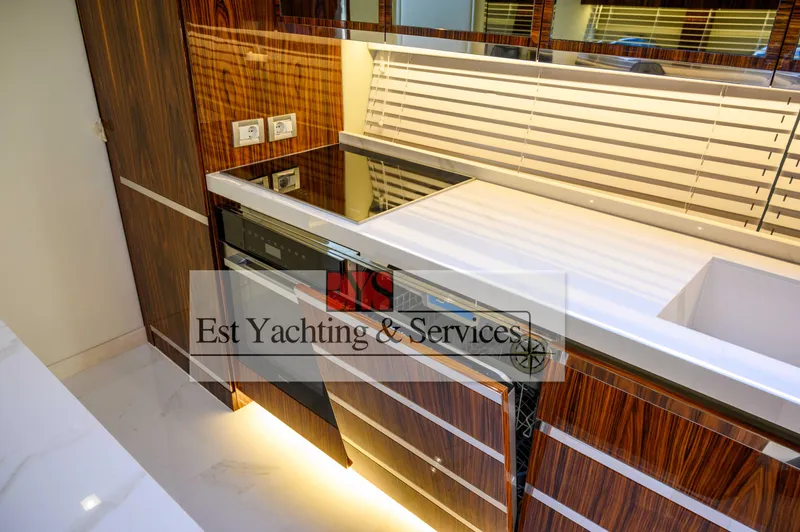  Yacht Photos Pics Luxurious kitchen interior of 2004 Sunseeker Predator 68 yacht with modern wood finish.