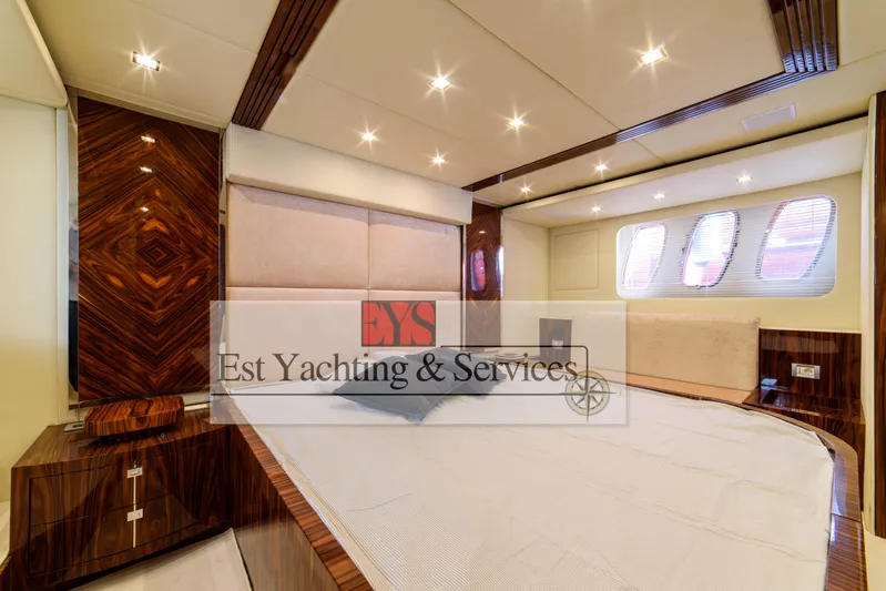  Yacht Photos Pics Luxurious interior of 2004 Sunseeker Predator 68 yacht bedroom with elegant wood finishes.