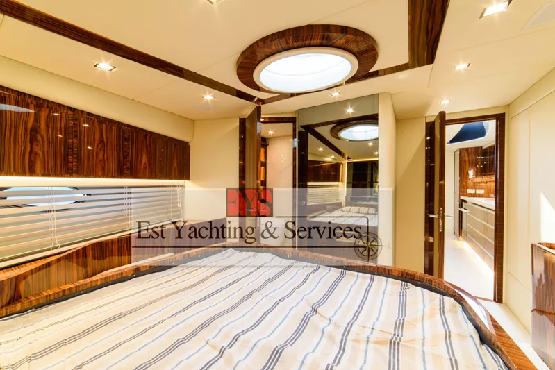  Yacht Photos Pics Luxurious bedroom interior of 2004 Sunseeker Predator 68 yacht with elegant wood finishes.