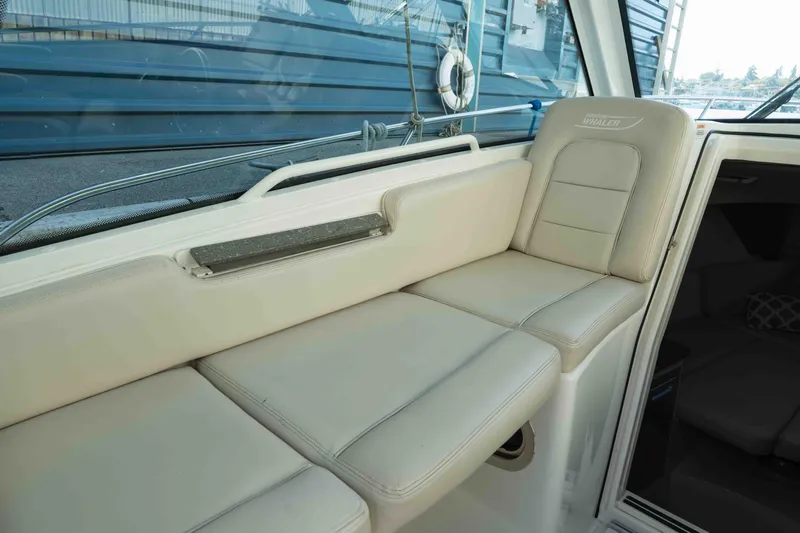  Yacht Photos Pics 2016 Boston Whaler 285 Conquest Pilothouse interior seating, beige upholstery, sleek design.