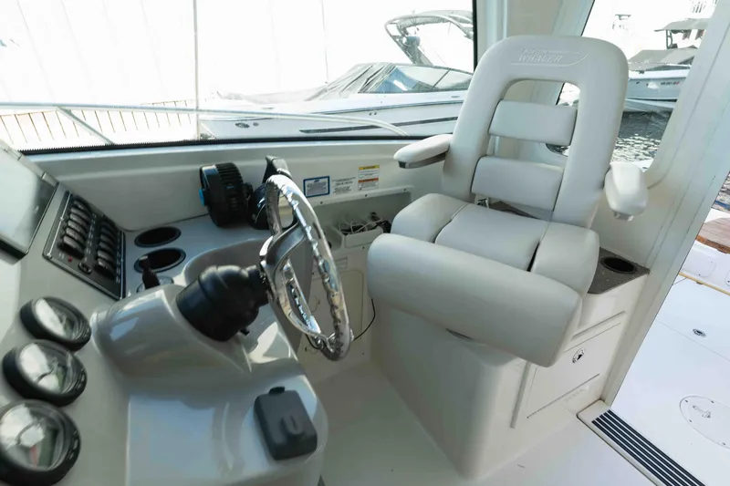  Yacht Photos Pics 2016 Boston Whaler 285 Conquest Pilothouse helm with steering wheel and captain's chair.
