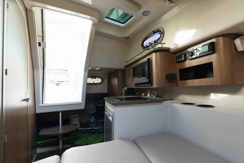  Yacht Photos Pics Interior of 2016 Boston Whaler 285 Conquest Pilothouse with kitchenette and seating area.