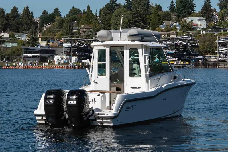  Yacht Photos Pics 2016 Boston Whaler 285 Conquest Pilothouse on water, twin 225 engines, scenic background.