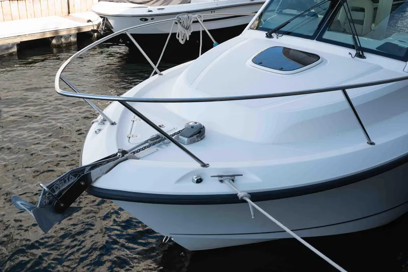  Yacht Photos Pics 2016 Boston Whaler 285 Conquest Pilothouse boat docked, showcasing anchor and bow details.