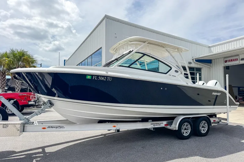  Yacht Photos Pics 2023 Pursuit DC 266 Dual Console boat on trailer outside dealership.
