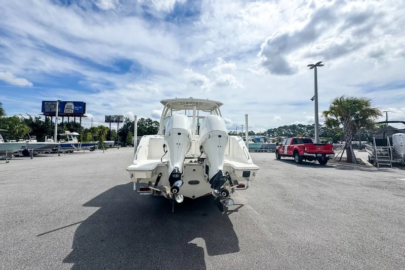  Yacht Photos Pics 2023 Pursuit DC 266 Dual Console boat with twin engines in a parking lot.