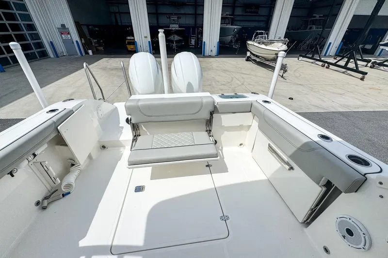  Yacht Photos Pics 2023 Pursuit DC 266 Dual Console boat interior with seating and storage compartments.