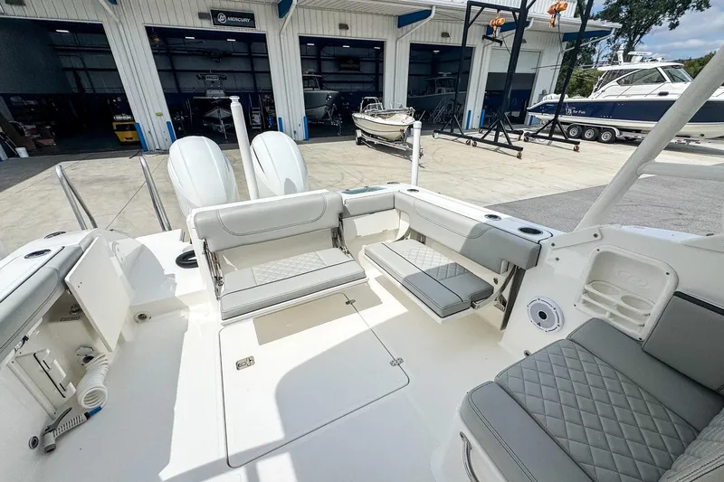  Yacht Photos Pics 2023 Pursuit DC 266 Dual Console boat interior with seating, docked at a marina.