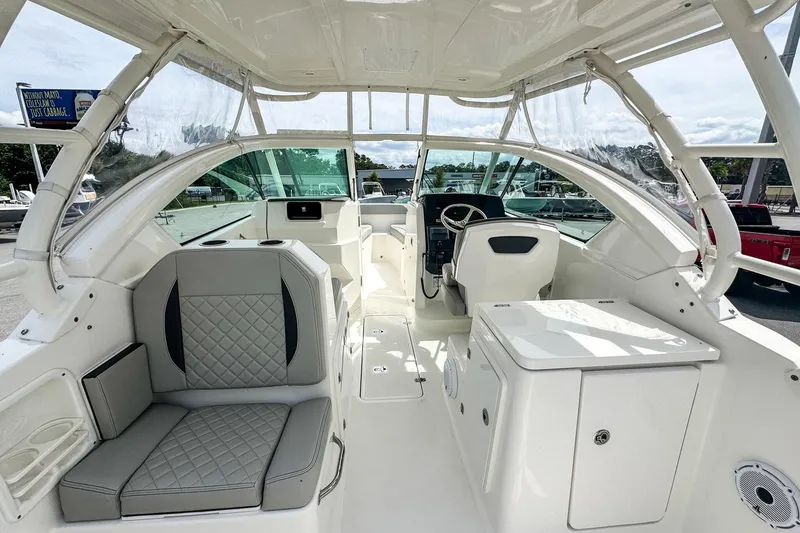  Yacht Photos Pics 2023 Pursuit DC 266 Dual Console boat interior with seating and helm station.