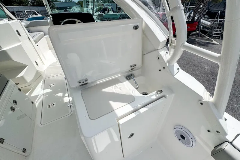  Yacht Photos Pics 2023 Pursuit DC 266 Dual Console boat interior with open storage compartment and seating area.