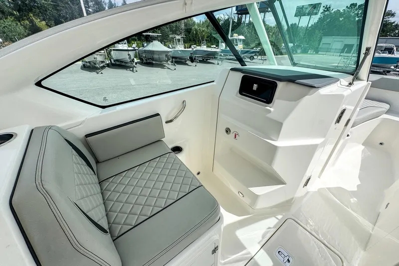 Yacht Photos Pics 2023 Pursuit DC 266 Dual Console interior with cushioned seating and modern dashboard.