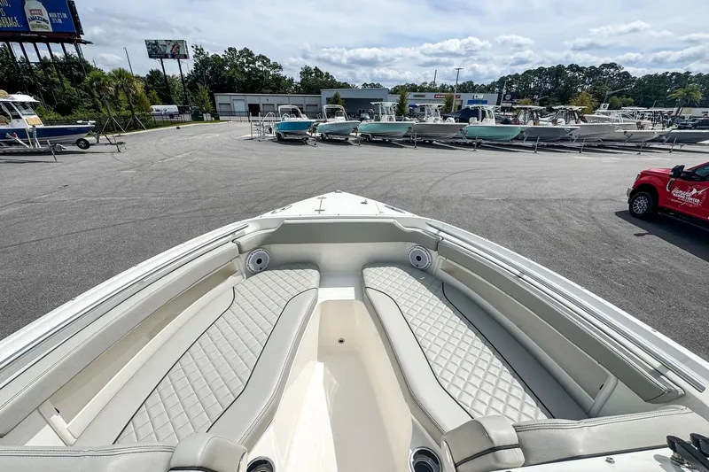  Yacht Photos Pics 2023 Pursuit DC 266 Dual Console boat with spacious seating at a marina.