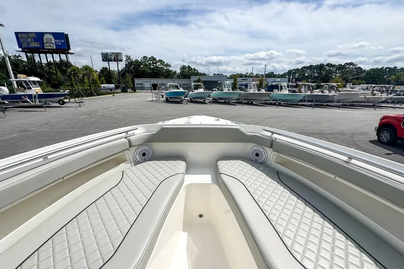  Yacht Photos Pics 2023 Pursuit DC 266 Dual Console boat interior with quilted seating in a marina.