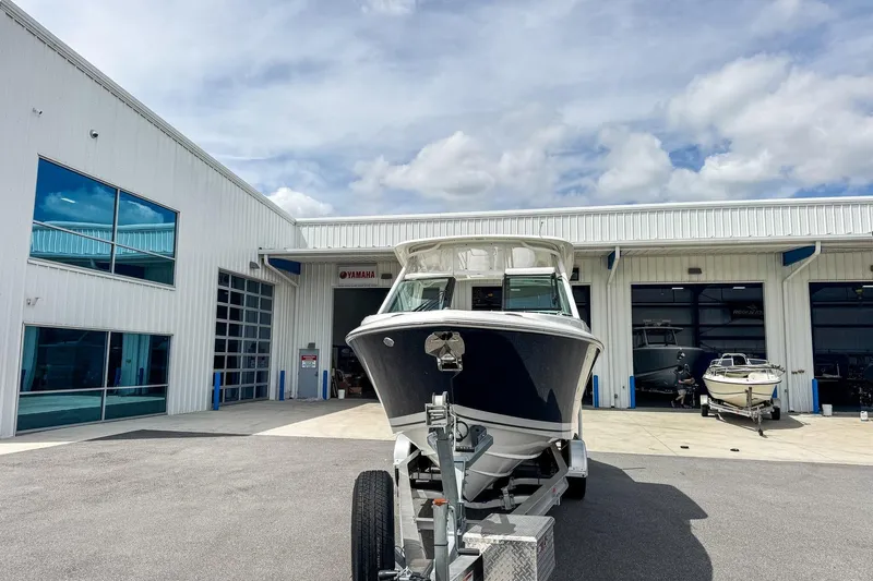  Yacht Photos Pics 2023 Pursuit DC 266 Dual Console boat on trailer outside dealership.