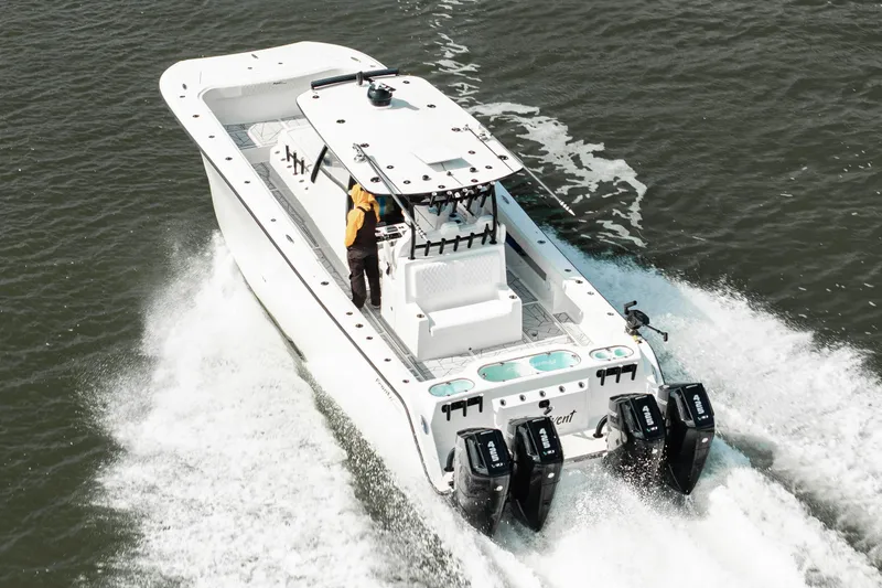  Yacht Photos Pics 2024 Front Runner 37 Catamaran cruising on water, featuring powerful outboard engines.